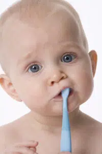 A Baby With His First Toothbrush